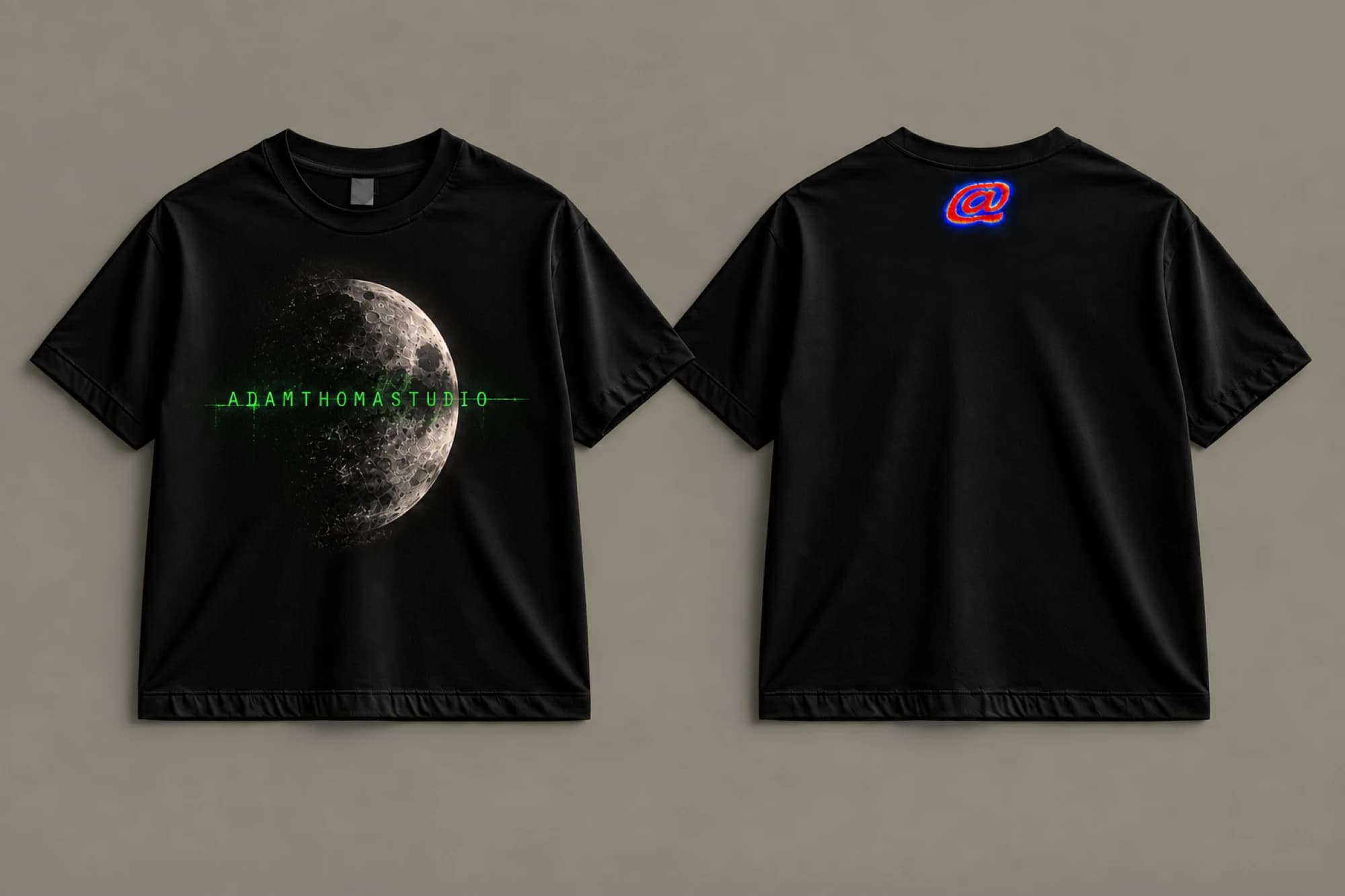Front and back of a black ORBIT / LUNAR HALF T-shirt with a cratered half moon, green ADAMTHOMASTUDIO lettering and a small thermal-color back logo.